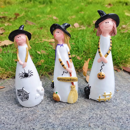 Halloween cute witch figurines standing outdoors